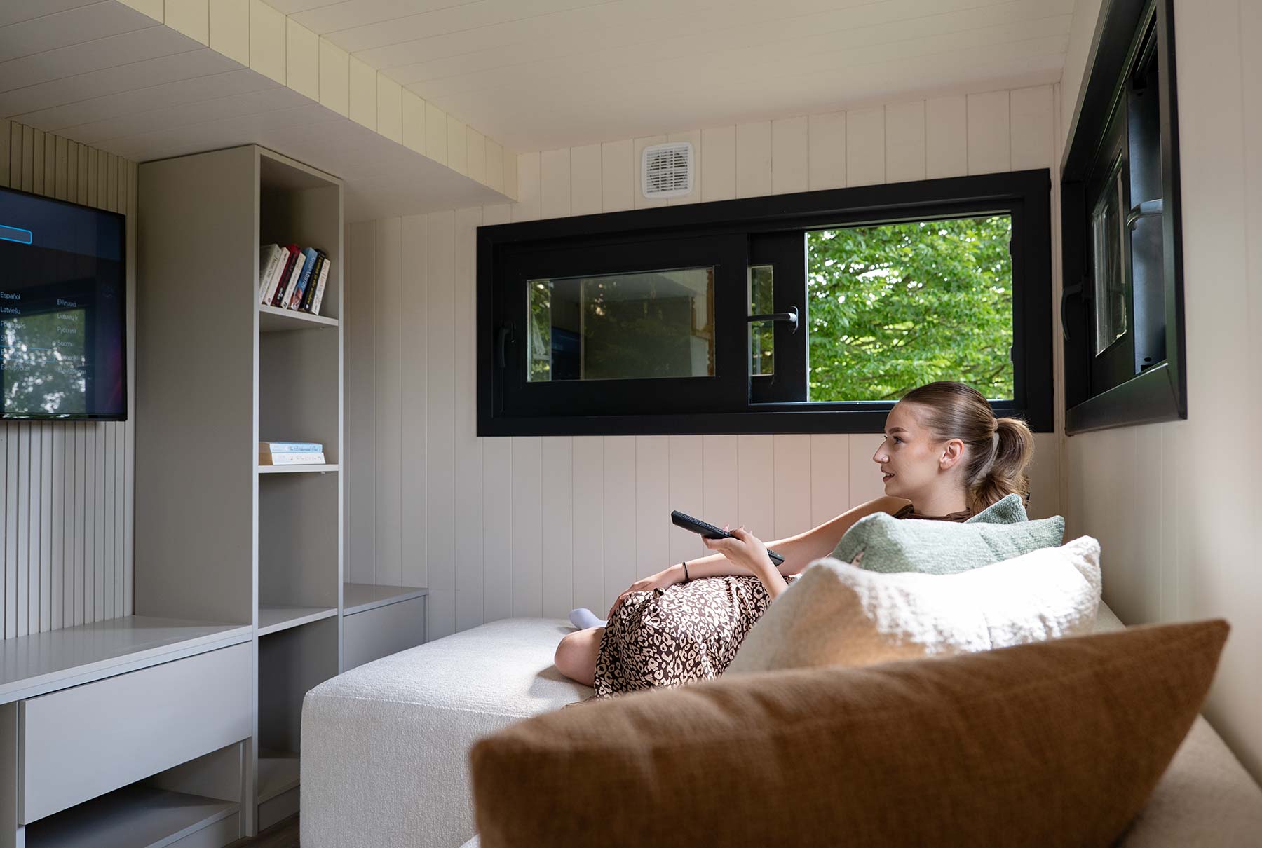 A girl watching television in a tiny house